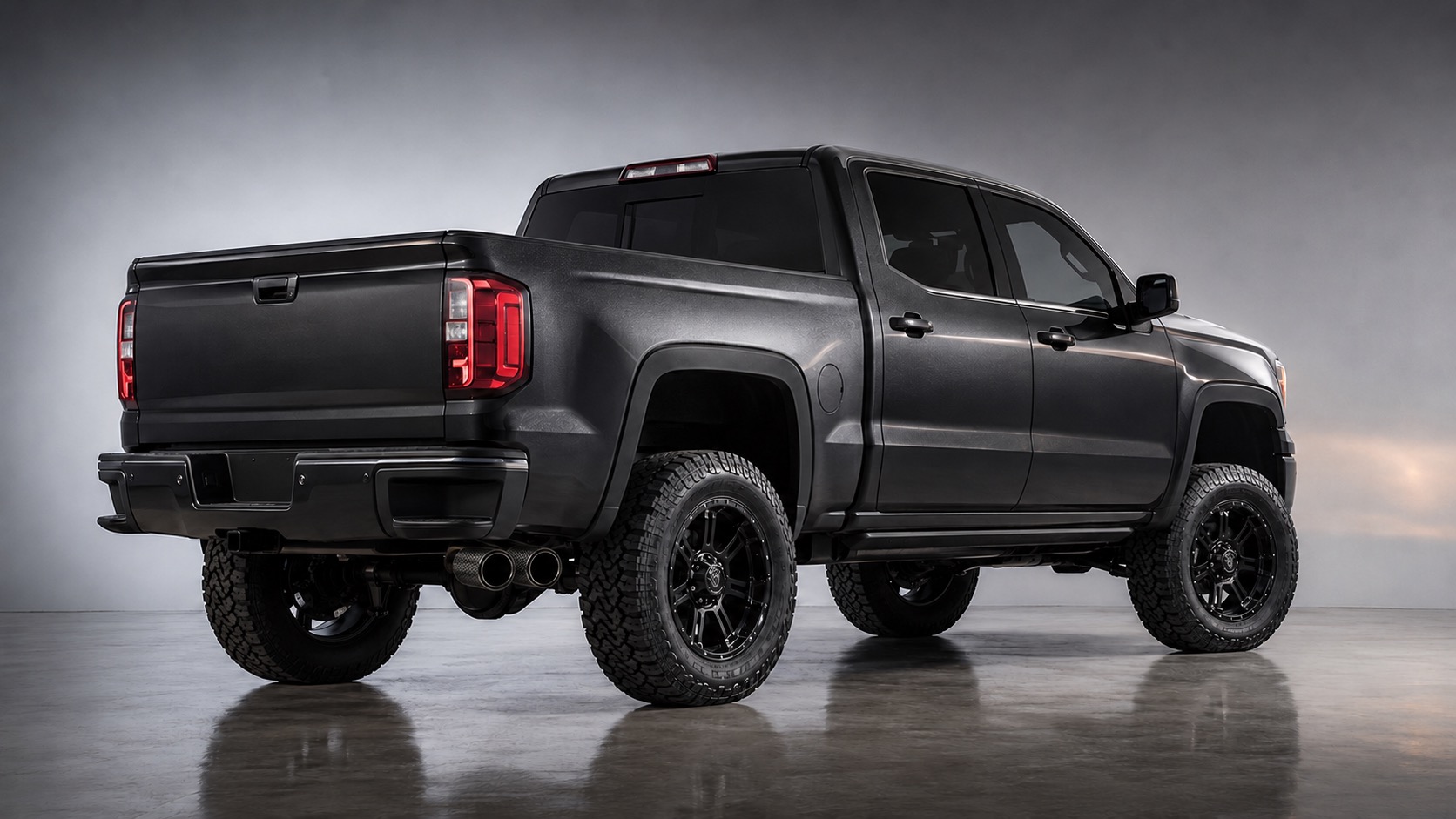 Lifted matte-black GMC Sierra crew-cab truck, rear three-quarter view with blacked-out wheels and dual exhaust tips